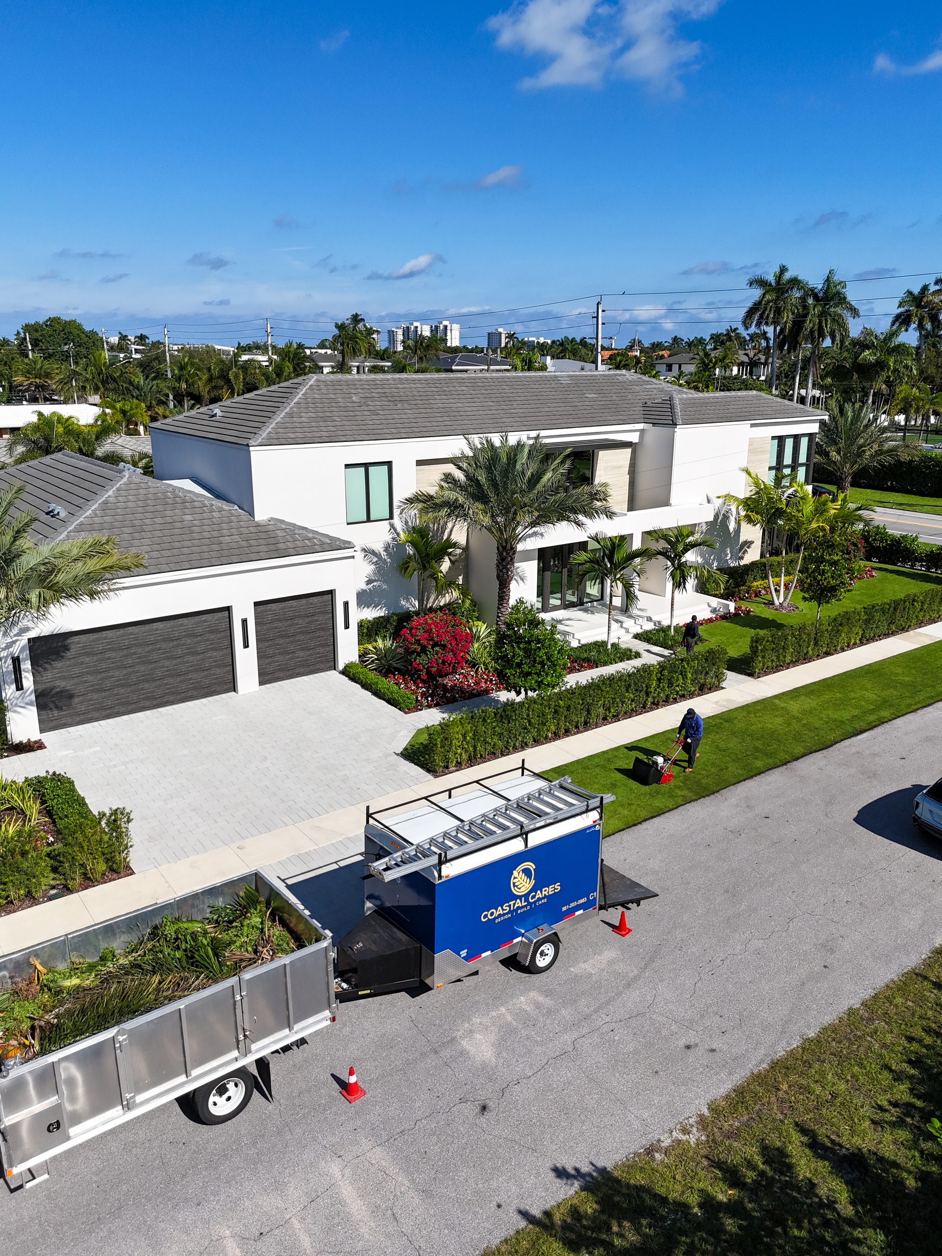 Aerial view of a Palm Beach oceanfront estate with manicured symmetrical gardens