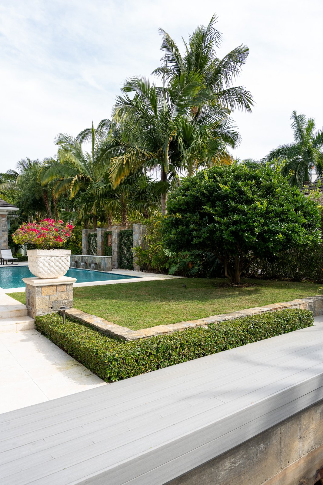 Lush green turf and curated plantings at an estate